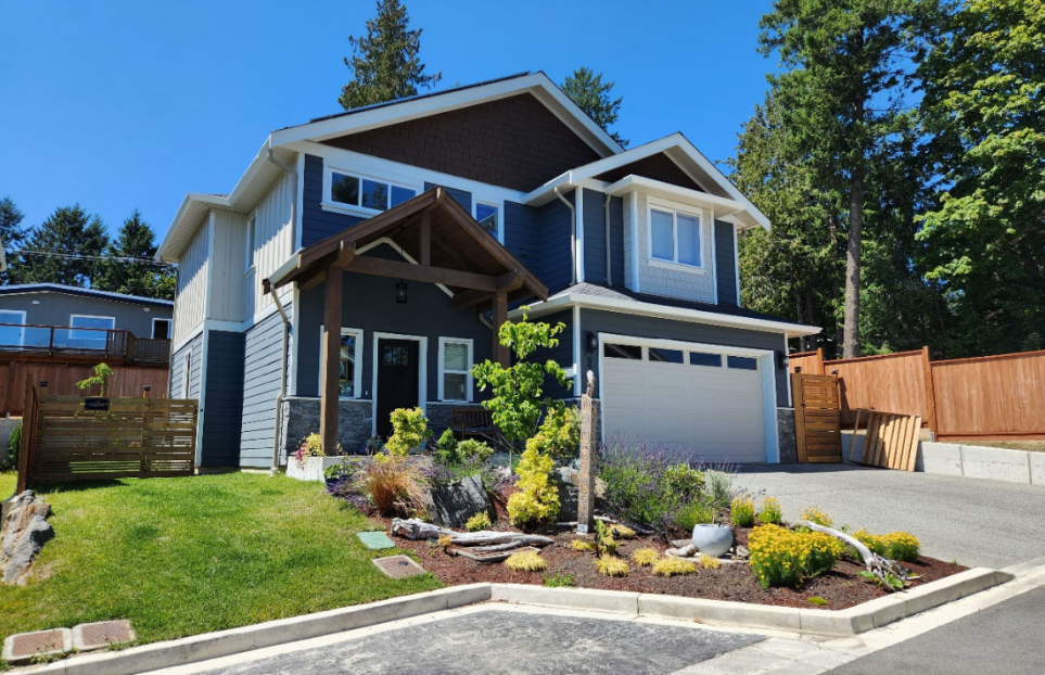 Detached home with landscaped front garden and driveway at Timber Ridge Phase 2 in Central Saanich, built by Walking Stick Developments Inc.