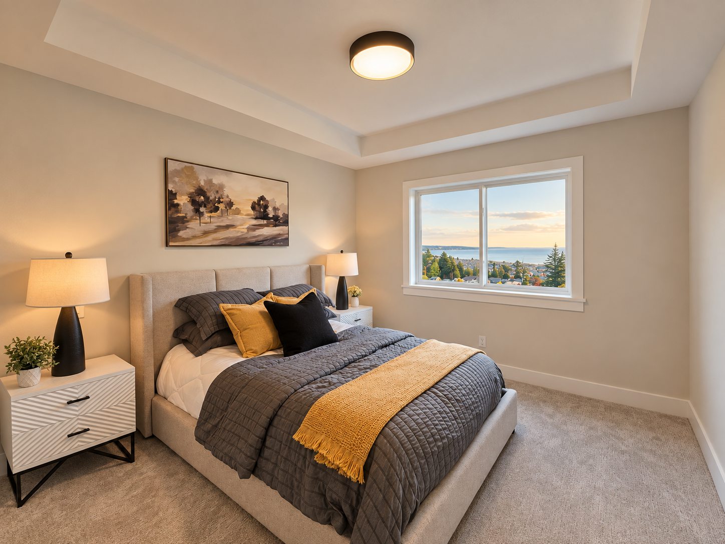 Coastwoods Phase 1 primary bedroom with a tray ceiling and an ocean view window