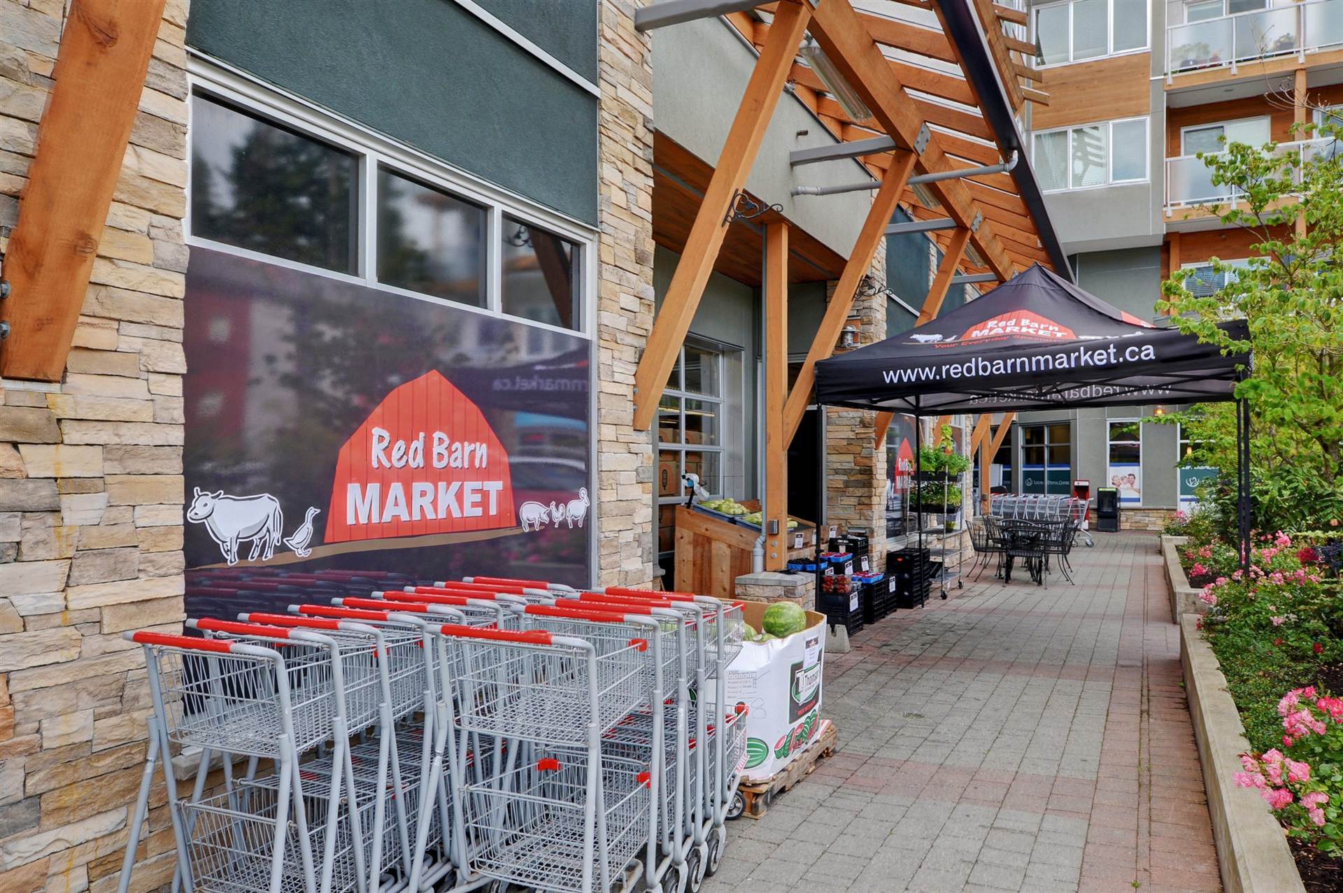 Red Barn Market storefront on the West Shore, with shopping carts and produce displays outside
